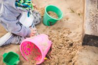 Kleinkind spielt im Sandkasten